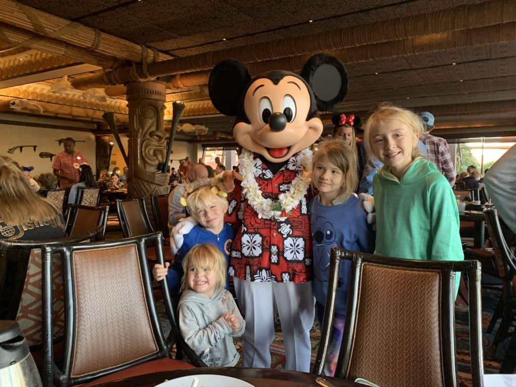 4 kids with Mickey mouse in Hawaiian outfit