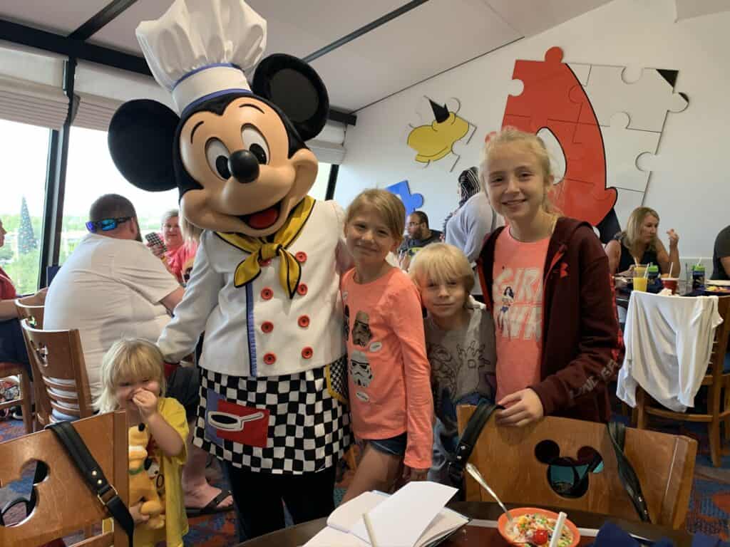 4 kids with mickey mouse in her chef outfit